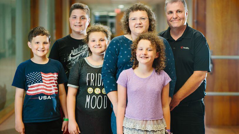 Paula and Rick Mounce (right) of Lebanon have two sets of twins: Kyle (left) and Keith, age 14, and Kaitlyn (center, in black shirt) and Kaylee, who are nearly 11. CONTRIBUTED