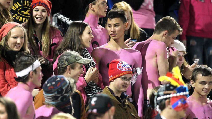 Local football fans wear pink during a 2013 game. STAFF FILE PHOTO