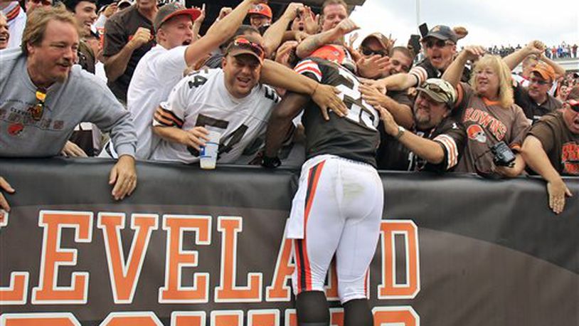 Cleveland Browns running back Chris Ogbonnaya (25) leaps into the Dawg Pound after a 1-yard touchdown catch against the Cincinnati Bengals in the fourth quarter of an NFL football game on Sunday, Sept. 29, 2013, in Cleveland. (AP Photo/Tony Dejak)