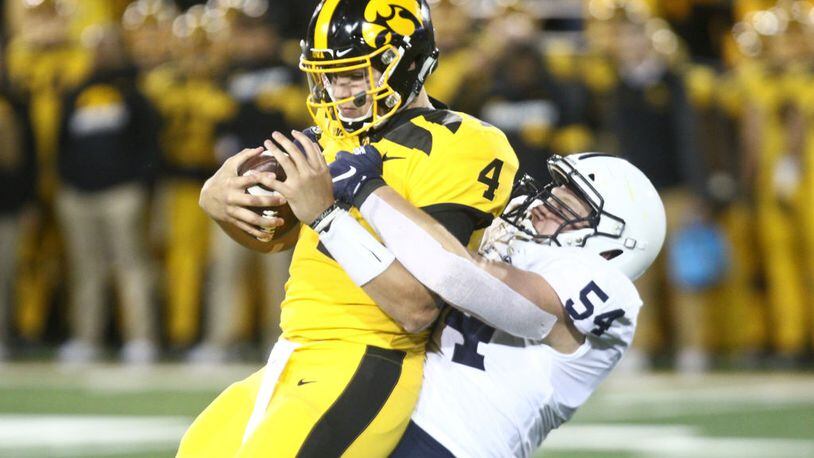 IOWA CITY, IOWA- OCTOBER 12:  Quarterback Nate Stanley #4 of the Iowa Hawkeyes is sacked during the second half by defensive tackler Robert Windsor #54 of the Penn State Nittany Lions on October 12, 2019 at Kinnick Stadium in Iowa City, Iowa.  (Photo by Matthew Holst/Getty Images)