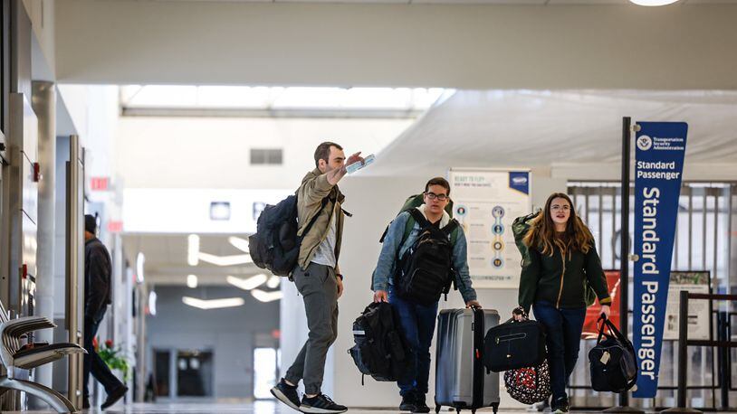 Travelers at the Dayton International Airport walk to the TSA checkpoint Friday November 18, 2022. Jim Noelker/Staff