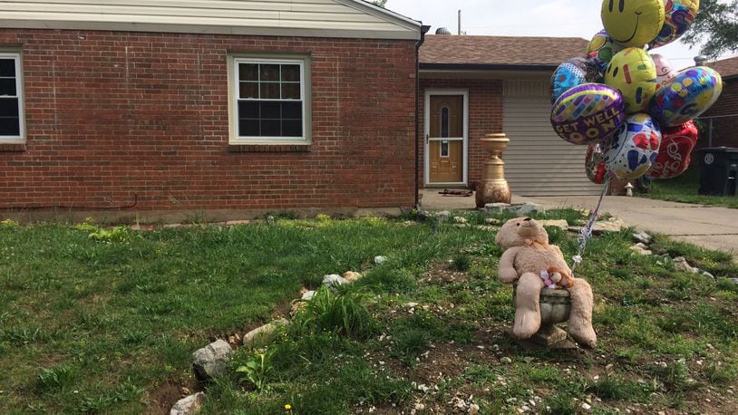 Neighbors have added to a makeshift memorial at the home on Lori Sue Avenue where two children were shot, May 18, 2017.