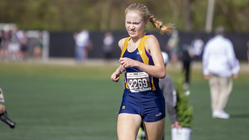 Oakwood senior Bella Butler presses toward the finish line Saturday to win the Division II state cross country championship at Fortress Obetz. CONTRIBUTED/Jeff Gilbert