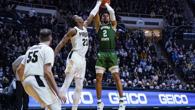 Wright State guard Tanner Holden (2) shoots over Purdue guard Jaden Ivey (23) during the first half of an NCAA college basketball game in West Lafayette, Ind., Tuesday, Nov. 16, 2021. (AP Photo/Michael Conroy)