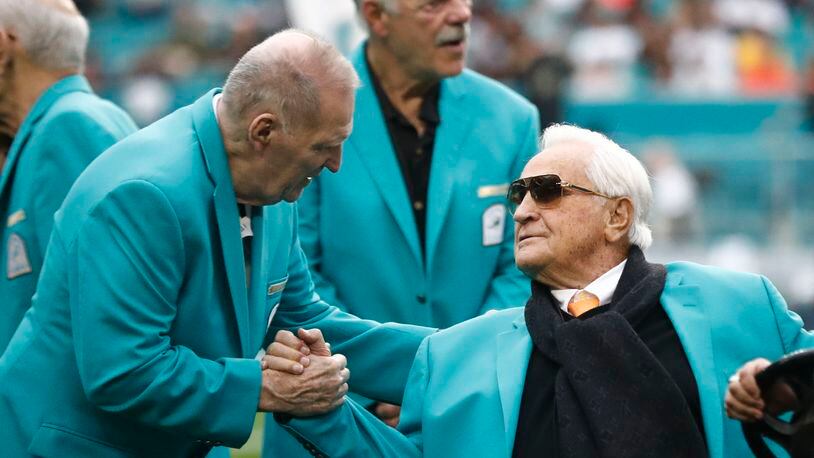 Former Miami Dolphins head coach Don Shula is greeted on the field by former players during half time at an NFL football game against the Cincinnati Bengals, Sunday, Dec. 22, 2019, in Miami Gardens, Fla. The 1972 undefeated team was celebrated on the field.