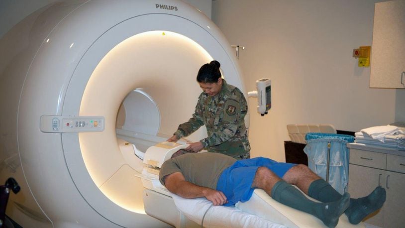 The 88th Medical Group’s Magnetic Resonance Imaging Technologists Tech. Sgt. Mariechrist Shuty (right) and Tech. Sgt. Timothy Carlson demonstrate how to properly and safely prepare a patient for an MRI of a patient’s head at Wright-Patterson Medical Center Sept. 18. The Diagnostic Imaging Flight’s MRI section performs more than 5,000 patient scans a year to assist doctors with treating patients. (U.S. Air Force photo/Leticia Hopkins)