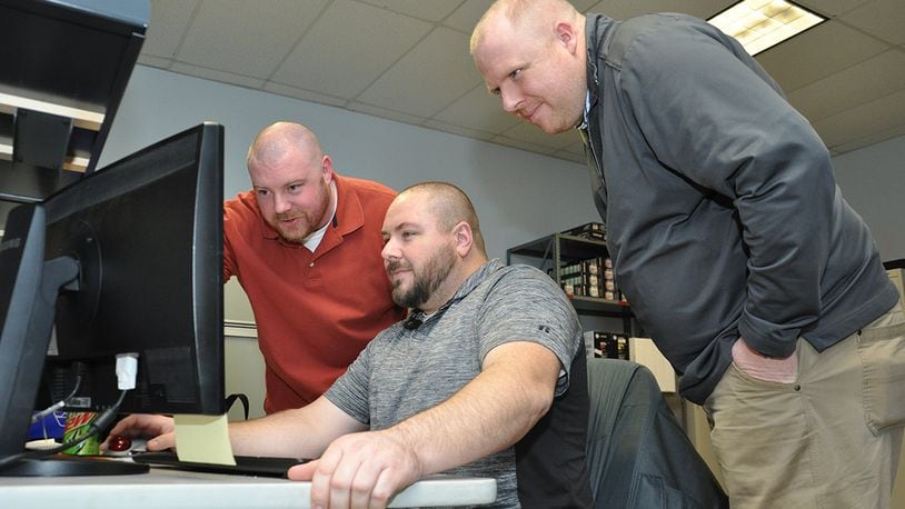 The Windows 10 migration was a topic for discussion for James Languirand, Information Technology specialist, Dave Hall, Automated Data Processing Equipment custodian, and John Schipper, Helpdesk technician, as they worked together to ensure that Wright-Patterson Air Force Base’s Air Force Security Assistance Center, meets the Air Force’s March 31 deadline for the transition to the new operating system. (U.S. Air Force photo/Will Huntington)