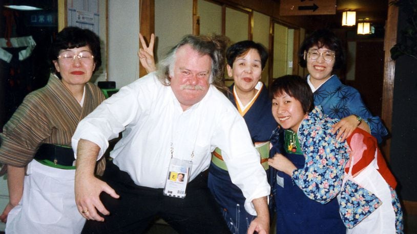 Tom Archdeacon celebrates the return of his camera with a sumo wrestling pose at the Winter Olympics in Nagano in 1998.