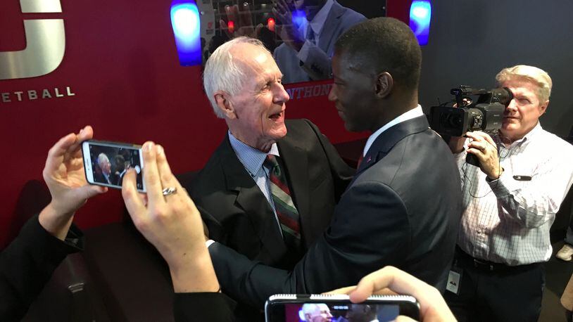 Don Donoher and Anthony Grant hug after his introductory press conference Saturday at UD Arena. David Jablonski/Staff