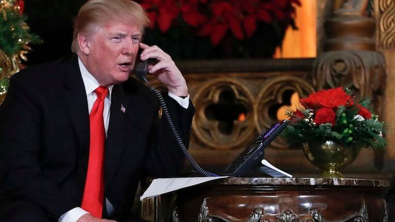 President Donald Trump speaks on the phone with children as they track Santa's movements with the North American Aerospace Defense Command (NORAD)  Santa Tracker on Christmas Eve at the president's Mar-a-Lago estate in Palm Beach, Fla., Sunday, Dec. 24, 2017. (AP Photo/Carolyn Kaster)