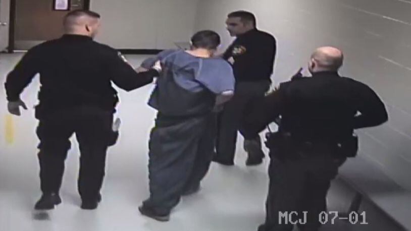 Montgomery County corrections officers escort Joseph Guglielmo to another cell for observation after he is injured in a fight with a jail sergeant. The incident led to a federal lawsuit.