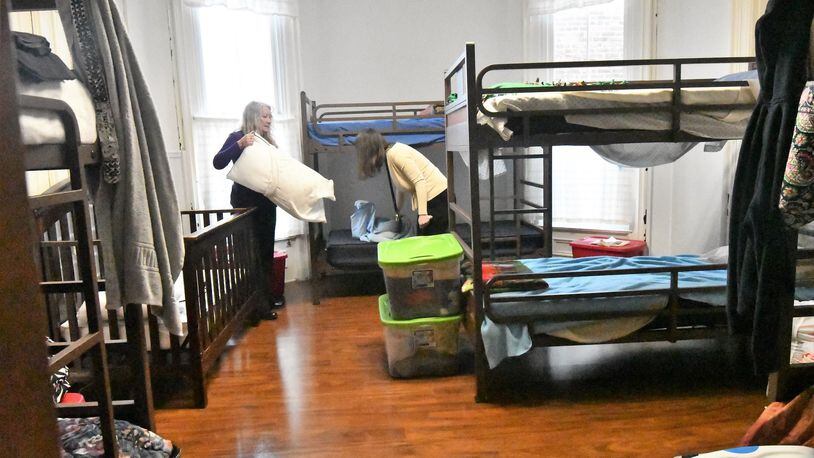 Employees of the Family Abuse Shelter of Miami County work in the dorm area of the shelter’s current home in Troy. The public fund raising campaign for a new building for shelter’s residents and operations is getting underway this month. CONTRIBUTED.