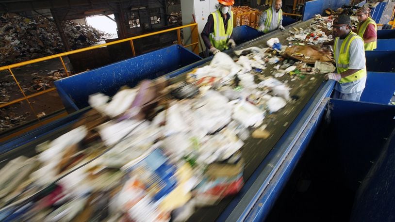 This file shows workers along a new pre-sorting machine at Rumpke Recycling in Dayton. Tightened rules from China are forcing companies to find new markets for recycled products and cut down on the amount of material that should not be put into recycling bins. TY GREENLEES / STAFF