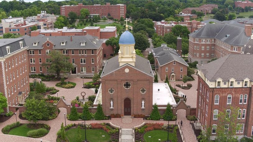 The iconic dome and cross on the Chapel of the Immaculate Conception is the centerpiece of UDs campus. The top of the cross is 95 feet above the ground. The cross is 7 feet, 4 inches tall from the ball to the top of the cross. The arms of the cross extend 4 feet, 6 inches.    TY GREENLEES / STAFF