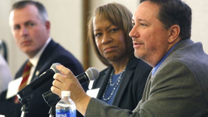 State Representative Robert Sprague, left, and Helen Jones-Kelley, executive director of the Alcohol, Drug Addiction and Mental Health Services for Montgomery County, listen as State Representative Jeff Rezabek makes a point about the opioid crisis during a recent Impact Ohio panel discussion. TY GREENLEES / STAFF
