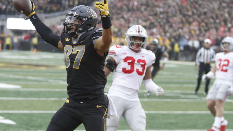 IOWA CITY, IOWA- NOVEMBER 04:  Tight end Noah Fant #87 of the Iowa Hawkeyes celebrates a touchdown during the second quarter in front of linebacker Dante Booker #33 of the Ohio State Buckeyes on November 04, 2017 at Kinnick Stadium in Iowa City, Iowa.  (Photo by Matthew Holst/Getty Images)