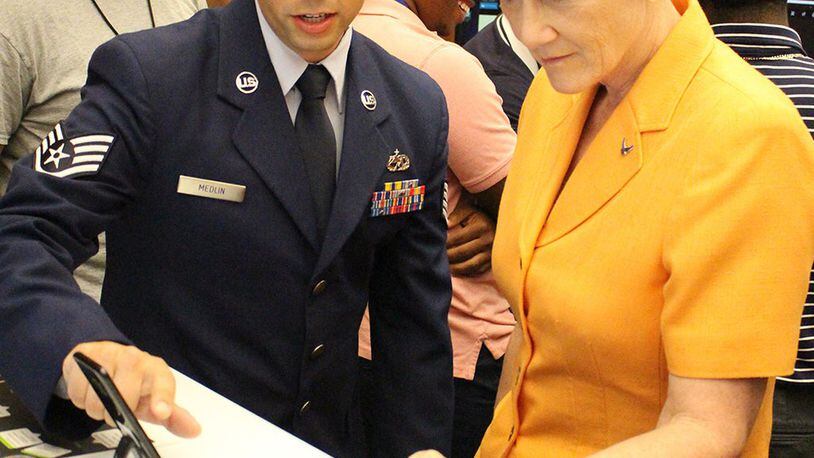 Staff Sgt. Sean Medlin (left), Lead Android developer for the Business and Enterprise Systems Directorate, explains the directorate’s first mobile application prototype to Secretary of the Air Force Dr. Heather Wilson during the Air Force Information Technology Conference in Montgomery, Ala., in August 2018. (U.S. Air Force photo/Ryan McCain)