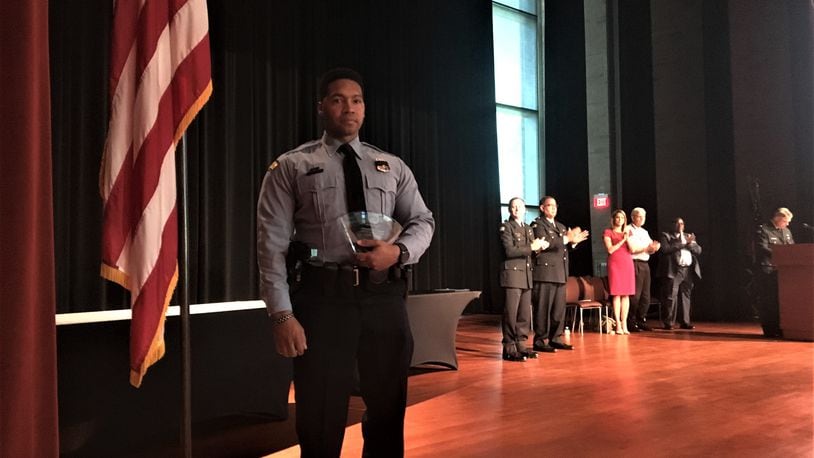 Dayton police officer Byron Branch holds his Officer of the Year Award. CORNELIUS FROLIK / STAFF
