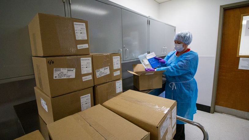 Yvonne Young, central sterilization and dispensing manager, receives shipment of swabs in Central Sterilization at the College of Dentistry, in Postle Hall at The Ohio State University. CONTRIBUTED