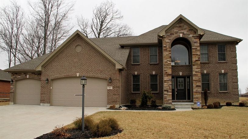 The brick-and-stone home, with 4 bedrooms and about 2,580 sq. ft. of living area, backs up to a common area where there is a pond. The property includes a 4-car garage with 2 separate bay doors. CONTRIBUTED PHOTOS BY KATHY TYLER