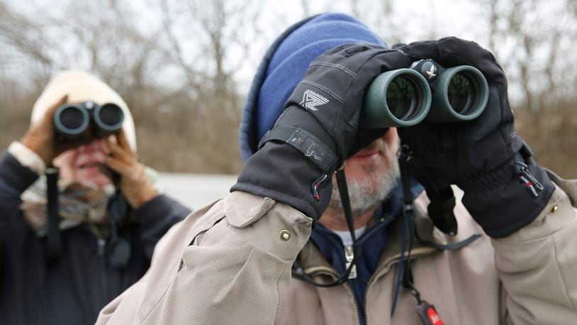 In this photo from 2017, Julie Karlson, left, and Doug Overacker use their binoculars to watch birds. Bill Lackey/Staff