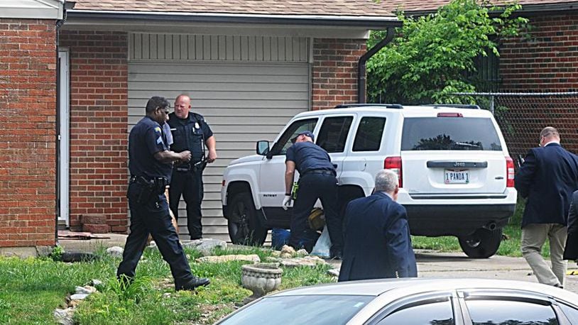 Dayton police officers are shown at the scene of a shooting of two children on Thursday, May 18.