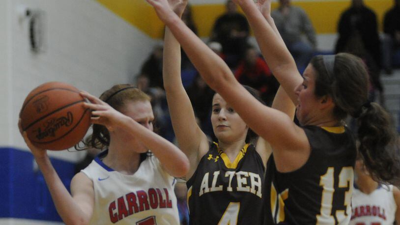 Carroll’s Sydney Ingram (with ball) is cut off by Alter’s Lauren Lush (4) and Olivia Gillis. Alter defeated Carroll 55-38 in a girls high school basketball D-II regional final at Springfield on Friday, March 10, 2017. MARC PENDLETON / STAFF