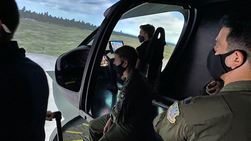 Air Force operators and engineers assess the BETA Technologies ALIA flight simulator. COURTESY PHOTO/BETA TECHNOLOGIES