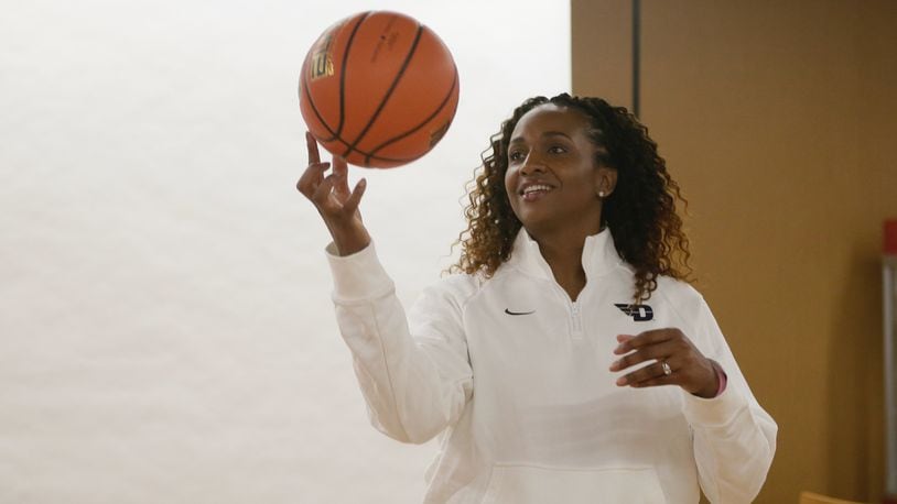 Tamika Williams-Jeter poses for a photo after being introduced as the new head women's basketball coach at Dayton on Monday, March 28, 2022, at UD Arena. David Jablonski/Staff
