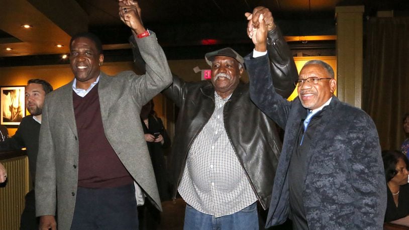 Joey Williams (left) and Jeff Mims Jr. (right) celebrate winning the Dayton City Commission race with former Dayton Mayor Richard Clay Dixon (center)Tuesday night. The incumbents were challenged by Darryl Fairchild and Shenise Turner-Sloss. LISA POWELL / STAFF