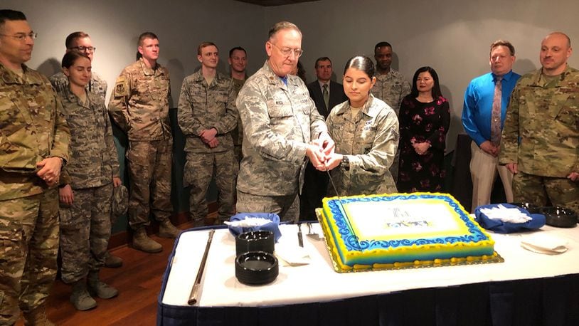 Maj. Anthony Wade, 88th Air Base Wing deputy chaplain, and Airman 1st Class Ashley Garcia, 88th Security Forces installation entry controller, cut a cake in celebration of the 75th anniversary of the 88th Air Base Wing April 5 in the Wright-Patterson Club. As part of the ceremony’s tradition, Wade and Garcia represented the oldest and youngest Airmen in the 88th Air Base Wing. (U.S. Air Force photo/Marie Vanover)