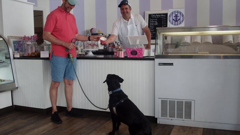 Teddy waiting patiently for his dad to get his ice cream from Erik Berakovich, the owner of Candy Harbor. KARIN SPICER