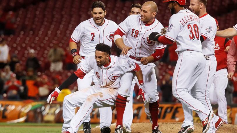 Cincinnati Reds’ Billy Hamilton (6) celebrates with Joey Votto (19) after hitting the game-winning RBI single in the 10th inning of a baseball game, Monday, May 1, 2017, in Cincinnati. The Reds won 4-3. (AP Photo/John Minchillo)