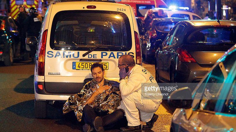 A medic tends to a man after an attack near the Boulevard des Filles-du-Calvaire November 13, 2015 in Paris, France. Gunfire and explosions in multiple locations erupted in the French capital with early casualty reports indicating at least 60 dead. (Getty)