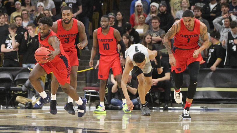 Dayton’s Jordan Davis picks up a loose ball against Colorado in the first round of the NIT on Tuesday, March 19, 2019, at the CU Events Center in Boulder, Colo. David Jablonski/Staff