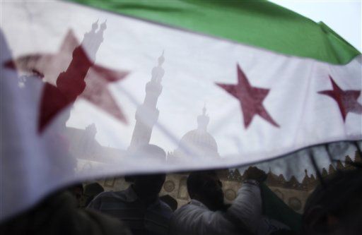 Protesters wave the Syrian revolution flag during a rally after the Friday prayer at Al-Azhar mosque in Cairo, Egypt.