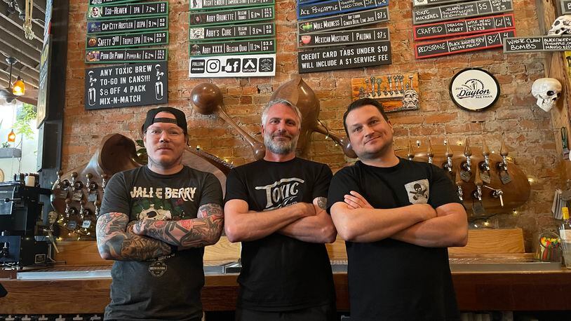 Toxic Brew Company, the first craft brewery in downtown Dayton, is celebrating its 10th anniversary. Pictured left to right is Tyler Glicher, Shane Juhl and Adam Stephens. NATALIE JONES/STAFF