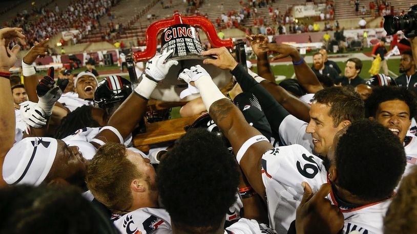 OXFORD, OH - SEPTEMBER 16: The Cincinnati Bearcats celebrate with the Victory Bell after defeating the Miami Ohio Redhawks 21-17 at Yager Stadium on September 16, 2017 in Oxford, Ohio. (Photo by Michael Reaves/Getty Images)