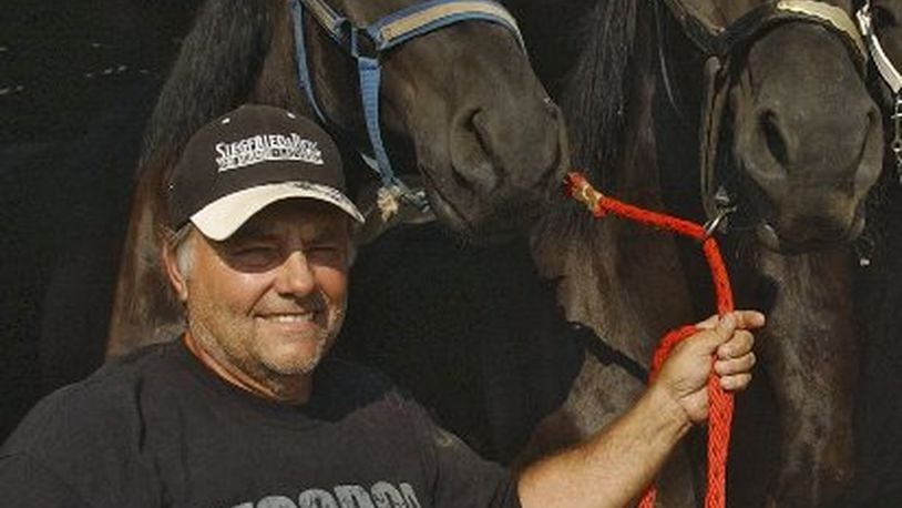 In an August 2008 photo, Terry Thompson stands with some of his award-winning Percheron horses on his farm west of Zanesville, Ohio. Authorities said Thompson, a game-preserve owner, apparently freed dozens of wild animals, including tigers and grizzly bears, and then killed himself on Oct. 18, 2011. (AP Photo/Zanesville Times Recorder, Chris Crook)