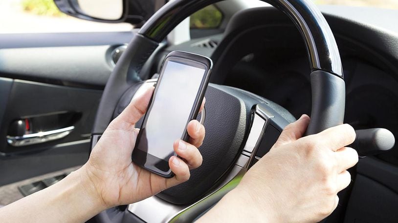 Checking Facebook, sending snapchats, tweeting or otherwise getting distracted while driving could get expensive in Ohio. Getty Image