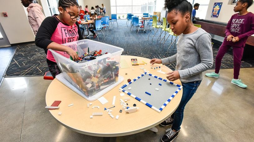 Fourth-graders Ayana, left, and Zoei, right, build with Legos on opening day at the Boys and Girls Club of West Chester/Liberty in the new location on Cincinnati Dayton Road in West Chester Township Thursday, Jan. 4. NICK GRAHAM/STAFF