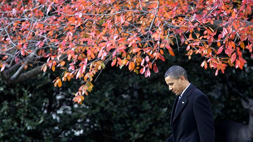 In this Dec. 6, 2010, file photo, President Barack Obama walks across the South Lawn of the White House in Washington, to board Marine One helicopter as he travels to Winston-Salem, N.C. More than half of Americans view President Barack Obama favorably as he leaves office, a new poll shows, but Americans remain deeply divided over his legacy. Less than half of Americans say they're better off eight years after his election or that Obama brought the country together.