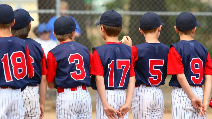 Little League players standing in line before a game.