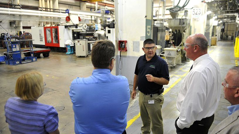 Dan Szklany, plant manager at Orbis in Urbana, leads a tour of the plant for a group from Ohio-Hi Point and Triad in April 2017. Bill Lackey/Staff
