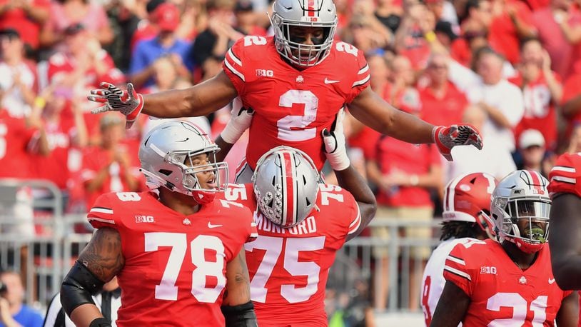 COLUMBUS, OH - OCTOBER 6:  J.K. Dobbins #2 of the Ohio State Buckeyes celebrates his first quarter touchdown run against the Indiana Hoosiers with Thayer Munford #75 of the Ohio State Buckeyes at Ohio Stadium on October 6, 2018 in Columbus, Ohio.  (Photo by Jamie Sabau/Getty Images)