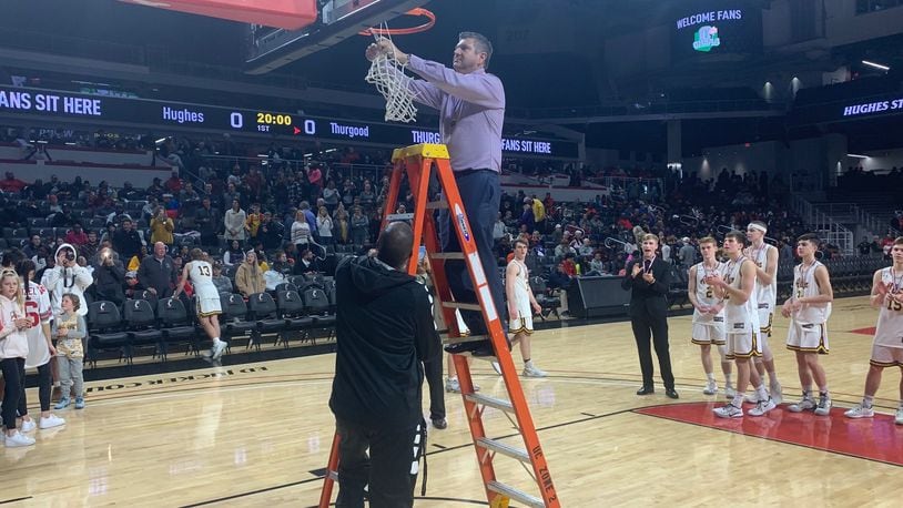 Alter coach Eric Coulter cuts down the net after the Knights beat previously unbeaten Cincinnati Wyoming in a Division II district final Friday night at the University of Cincinnati. Eric Frantz/CONTRIBUTED
