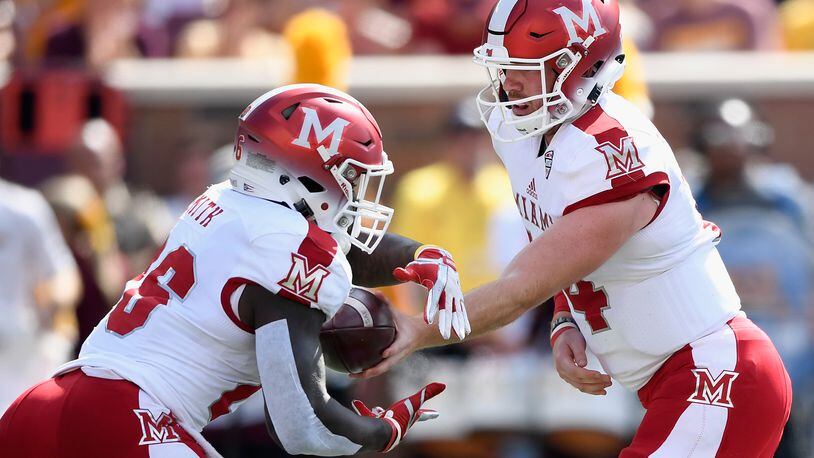 MINNEAPOLIS, MN - SEPTEMBER 15: Gus Ragland #14 of the Miami (Oh) Redhawks hands the ball to teammate Alonzo Smith #26 during the first quarter of the game on September 15, 2018 at TCF Bank Stadium in Minneapolis, Minnesota. (Photo by Hannah Foslien/Getty Images)