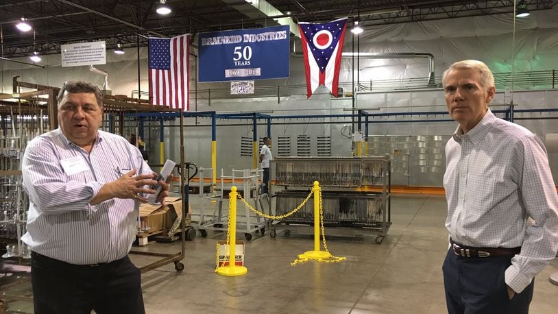 Gregory Fritz, left, president of Brainerd Industries, shows Sen. Rob Portman, R-Ohio, around his Precision Court production facility last week. THOMAS GNAU/STAFF
