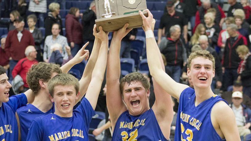 Marion Local’s Tyler Prenger (left), Tyler Mescher and Justin Albers hoist the D-IV regional trophy. Marion Local defeated Fort Loramie 62-47 in a boys high school basketball D-IV regional final at Fairmont’s Trent Arena in Kettering on Fri., March 16, 2018. JEFF GILBERT / CONTRIBUTOR