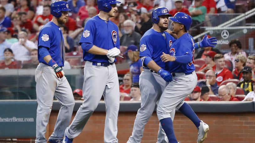 Chicago Cubs’ Kyle Schwarber, center right, celebrates with Jon Jay, right, Mike Montgomery, center left, and Ben Zobrist after hitting a three-run home run off Cincinnati Reds starting pitcher Asher Wojciechowski during the fourth inning of a baseball game, Wednesday, Aug. 23, 2017, in Cincinnati. (AP Photo/John Minchillo)